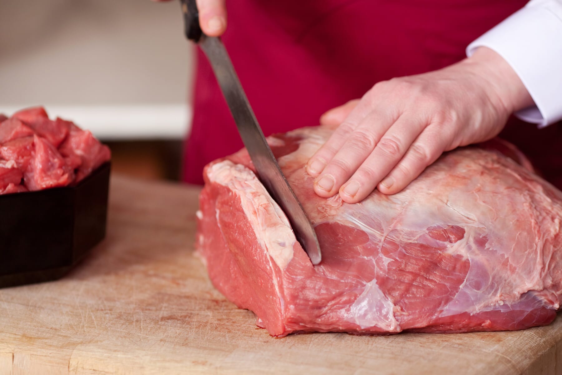 Grand Peaks Prime Meats butcher slicing meat